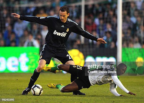 Cristoph Metzelder of Real Madrid tackles Papakouly Diop of Racing Santander during the La Liga match between Racing Santander and Real Madrid at El...