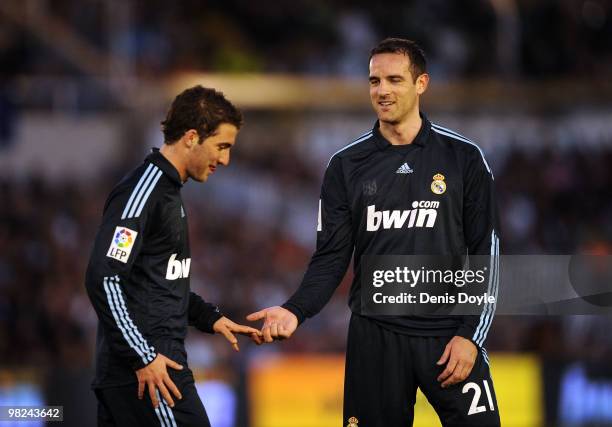 Cristoph Metzelder of Real Madrid congratulates Gonzalo Higuain after Higuain was substituted during the La Liga match between Racing Santander and...