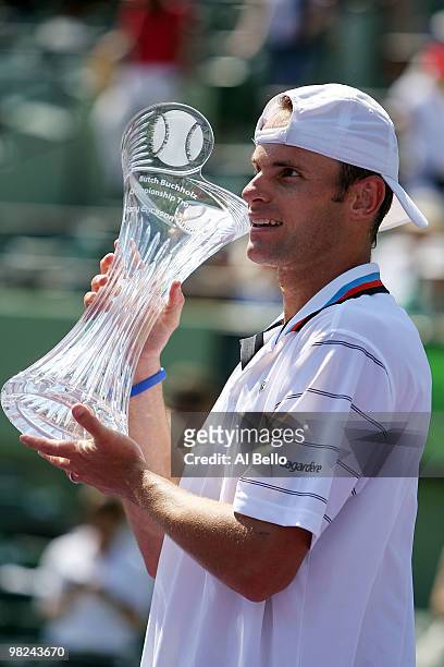 Andy Roddick of the United States holds up the trophy after defeating Tomas Berdych of the Czech Republic in straight sets to win the men's final of...