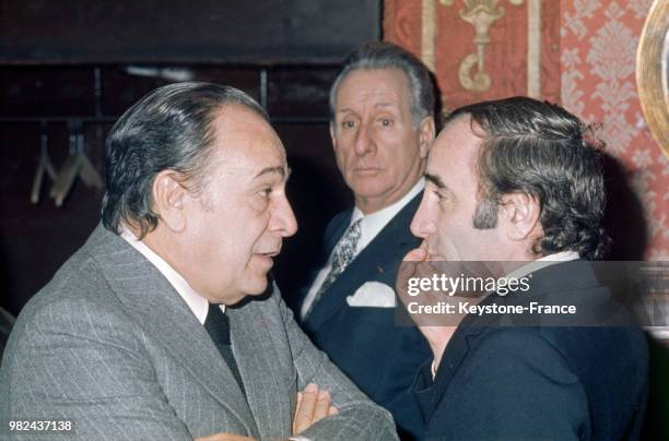Tino Rossi discutant avec Charles Aznavour, à Paris, France, le 17 janvier 1974.