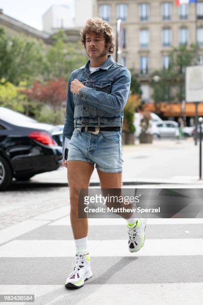 Guest is seen on the street during Paris Men's Fashion Week S/S 2019 wearing denim jacket and shorts with sneakers on June 23, 2018 in Paris, France.