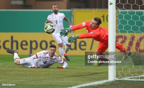 Paderborn's goalkeeper Michael Ratajczak blocks a header from Munich's Robert Lewandowski during the German DFB Cup soccer match between SC Paderborn...