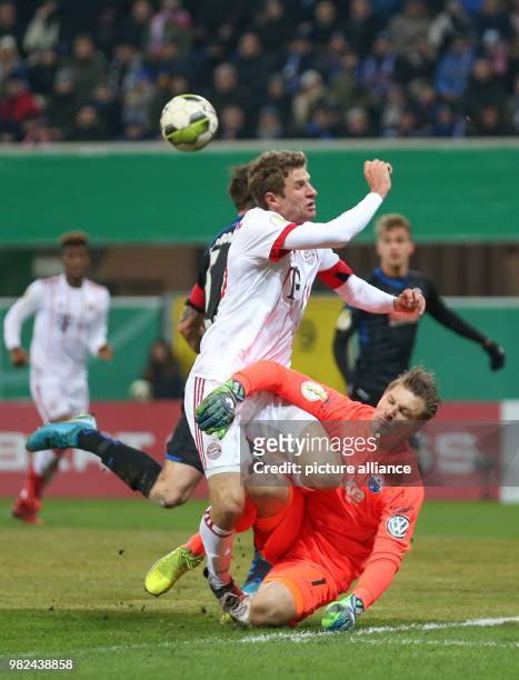 Paderborn's goalkeeper Michael Ratajczak and Munich's Thomas Mueller vie for the ball during the German DFB Cup soccer match between SC Paderborn and...