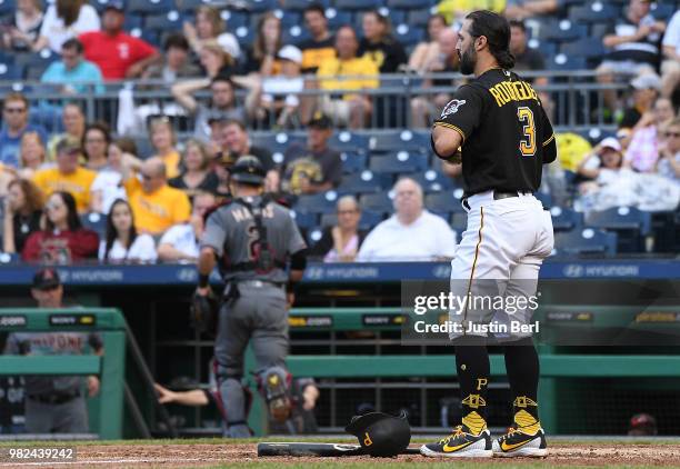 Sean Rodriguez of the Pittsburgh Pirates talks off his batting gloves after striking out looking in the fifth inning during the game Arizona...