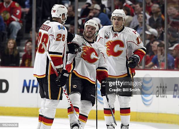 Ian White of the Calgary Flames celebrates with his teammates, including Rene Bourque, after scoring against the Chicago Blackhawks on April 04, 2010...