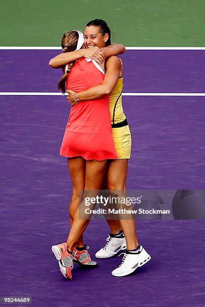 Gisela Dulko of Argentina and Flavia Pennetta of Italy celebrate after defeating Samantha Stosur of Australia and Nadia Petrova of Russia to win the...