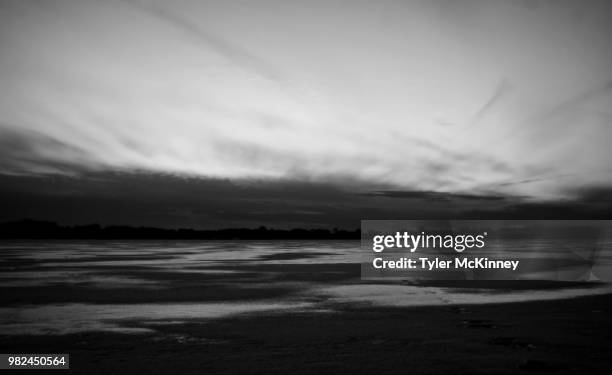 sunset over a frozen lake - kinney lake stock pictures, royalty-free photos & images