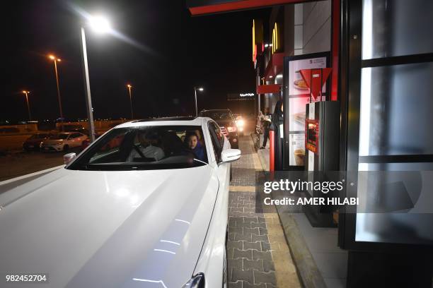 Saudi Samira Al-Ghamdi drives her car and waits in line to order from a fast food in the coastal city of Jeddah. For the first time little after...