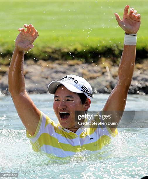 Champion Yani Tseng of Taiwan celebrates after jumping in the lake surrounding the 18th green after the final round of the Kraft Nabisco Championship...