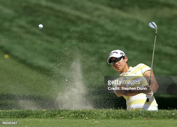 Yani Tseng of Taiwan hits out of a bunker on the 11th hole during the final round of the Kraft Nabisco Championship at Mission Hills Country Club on...