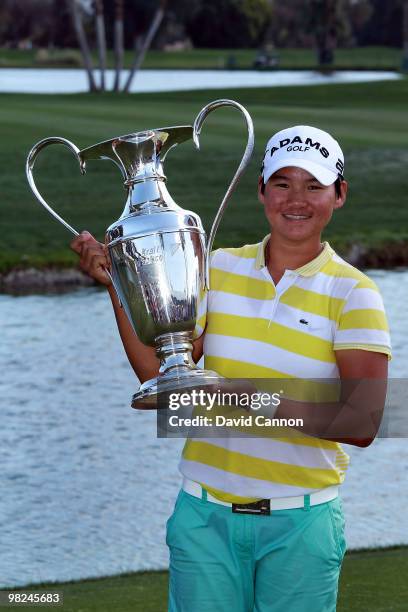 Yani Tseng of Taiwan proudly holds the trophy after her one shot victory in the 2010 Kraft Nabisco Championship, on the Dinah Shore Course at The...