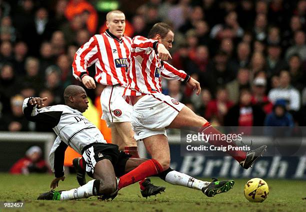Luis Boa Morte of Fulham tackles Lee Sandford the captain of Sheffield United during the Nationwide Division One match between Fulham and Sheffield...
