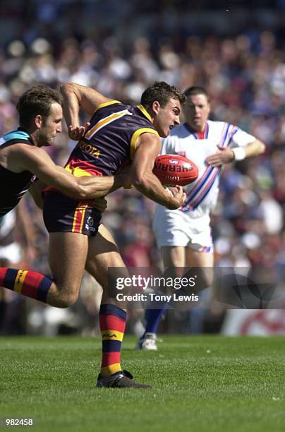 Andrew Crowell for Adelaide is tackled by Darryl Wakelin for Port Adelaide in the match between the Adelaide Crows and Port Power in round 3 of the...