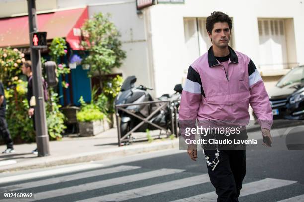 Marc Forne, wearing pink, black and white sweater and black pants, is seen in the streets of Paris before the Wooyoungmi show, during Paris Men's...
