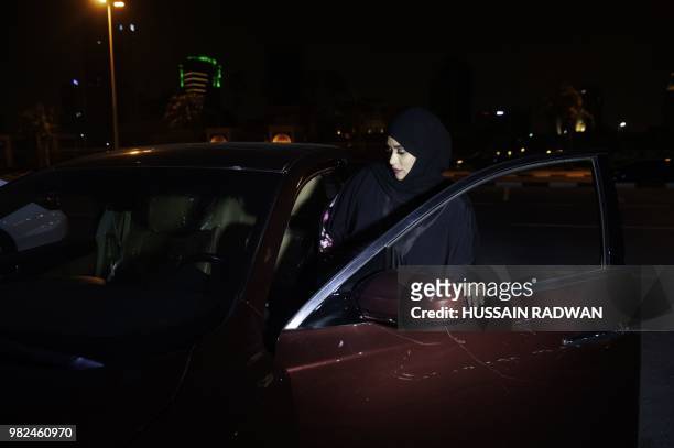 Saudi woman Sabika Habib gets ready to drive her car through the streets of Khobar City on her way to Kingdom of Bahrain. For the first time little...