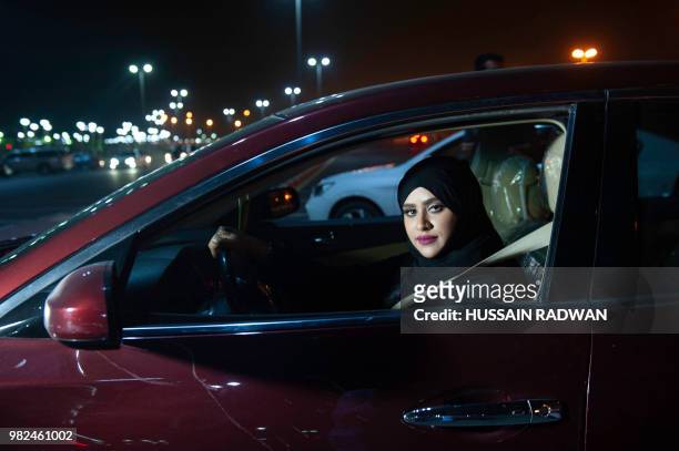 Saudi woman Sabika Habib drives her car through the streets of Khobar City on her way to Kingdom of Bahrain. For the first time little after midnight...