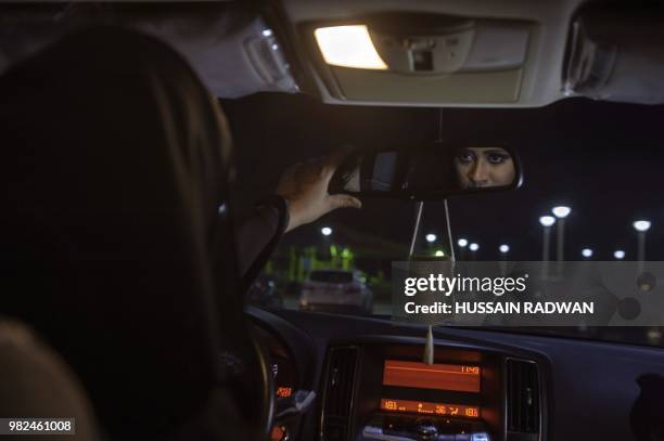 Saudi woman Sabika Habib drives her car through the streets of Khobar City on her way to Kingdom of Bahrain. For the first time little after midnight...