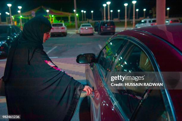 Saudi woman Sabika Habib gets ready to drive her car through the streets of Khobar City on her way to Kingdom of Bahrain. For the first time little...