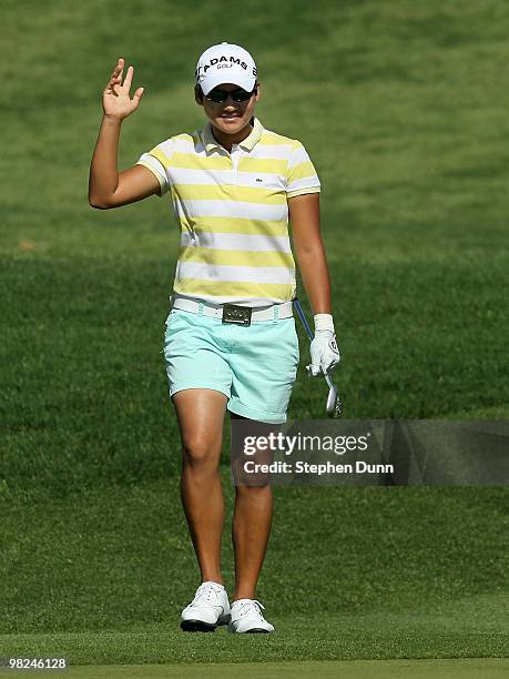 Yani Tseng of Taiwan waves chipping in for an eagle on the second hole during the final round of the Kraft Nabisco Championship at Mission Hills...