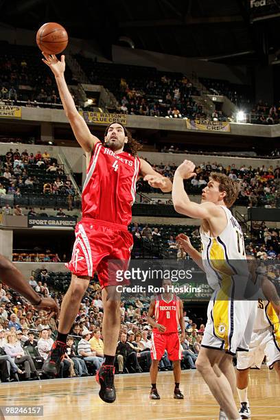 Luis Scola of the Houston Rockets shoots over Mike Dunleavy of the Indiana Pacers at Conseco Fieldhouse on April 4, 2010 in Indianapolis, Indiana....