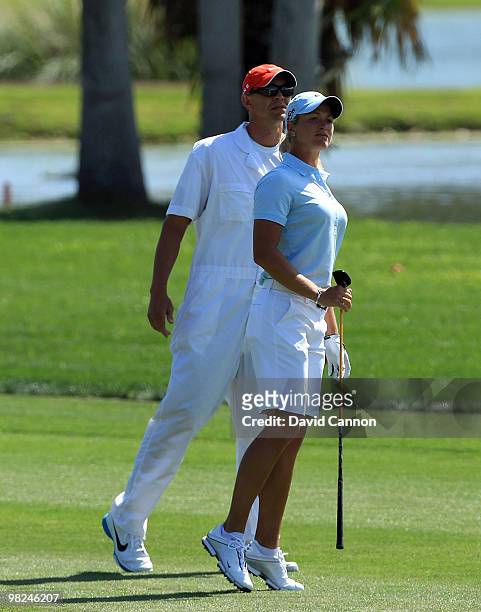 Suzann Petteresen of Norway watches her second shot over water on the 18th hole with her caddie Dave Brooker during the final round of the 2010 Kraft...