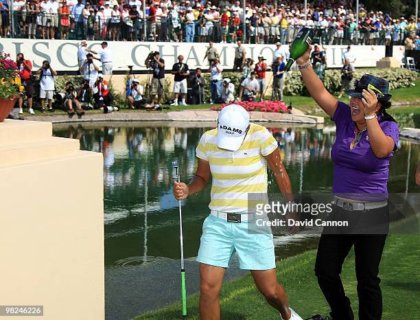 Yani Tseng of Taiwan is chased by fellow LPGA player Christina Kim after holing the winning putt on the 18th green during the final round of the 2010...