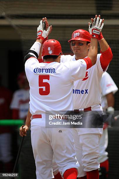 Carlos Valencia and Oscar Robles of Mexico Red Devils celebrate during a 2010 Liga Mexicana de Beisebol match between Mexico Red Devils and Vaqueros...