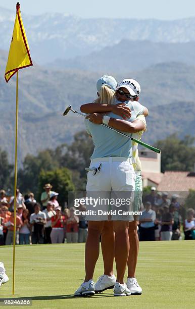 Yani Tseng of Taiwan embraces Suzann Pettersen of Norway after holing the winning putt on the 18th green during the final round of the 2010 Kraft...