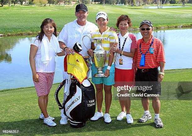 Yani Tseng of Taiwan poses with her caddie Dave Poitevent and her family after after her victory during the final round of the 2010 Kraft Nabisco...