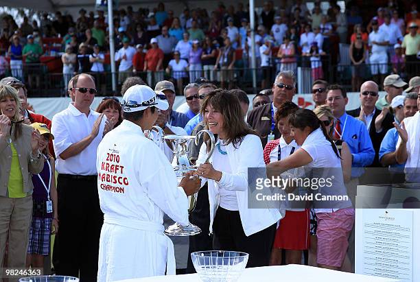 Yani Tseng of Taiwan is presented with the trophy after her one shot victory in the 2010 Kraft Nabisco Championship, on the Dinah Shore Course at The...
