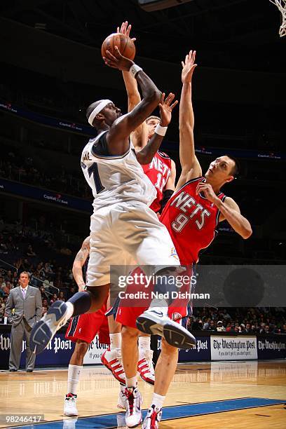 Andray Blatche of the Washington Wizards shoots against Yi Jianlian and Brook Lopez of the New Jersey Nets at the Verizon Center on April 4, 2010 in...