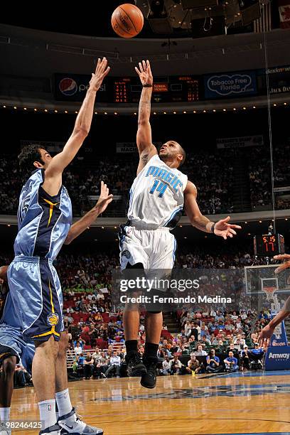 Jameer Nelson of the Orlando Magic shoots against Hamed Haddadi of the Memphis Grizzlies during the game on April 4, 2010 at Amway Arena in Orlando,...