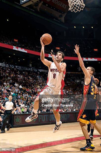 Jose Calderon of the Toronto Raptors drives hard to the net for the layup past Stephen Curry of the Golden State Warriors during a game on April 04,...