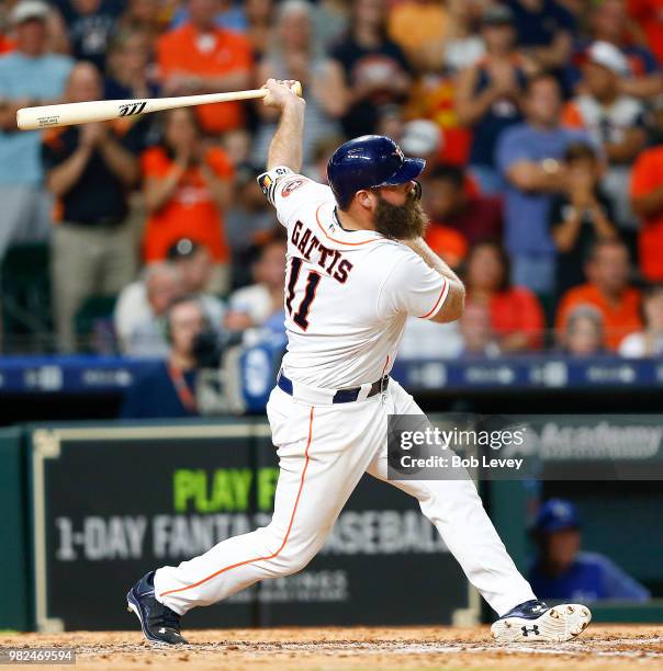 Evan Gattis of the Houston Astros hits a sacrifice fly in the ninth inning against the Kansas City Royals at Minute Maid Park on June 23, 2018 in...