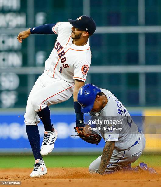 Carlos Correa of the Houston Astros tags out Adalberto Mondesi of the Kansas City Royals trying to steal second base in the ninth inning at Minute...