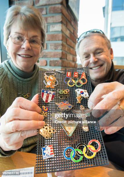 Pin-traders Linda and Peter Wade from Cincinnati, USA show their Olympic pin collection at the Winter Olympics Pyeongchang in Gangneung, South Korea,...