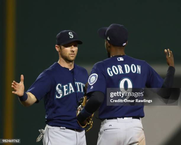 Dee Gordon of the Seattle Mariners and Andrew Romine of the Seattle Mariners celebrate after defeating the Boston Red Sox 7-2 at Fenway Park on June...