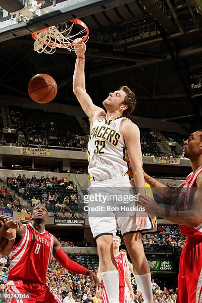 Josh McRoberts of the Indiana Pacers jams onver Jermaine Taylor of the Houston Rockets at Conseco Fieldhouse on April 4, 2010 in Indianapolis,...