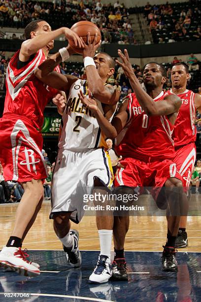 Earl Watson of the Indiana Pacers battles Kevin Martin and Aaron Brooks of the Houston Rockets at Conseco Fieldhouse on April 4, 2010 in...