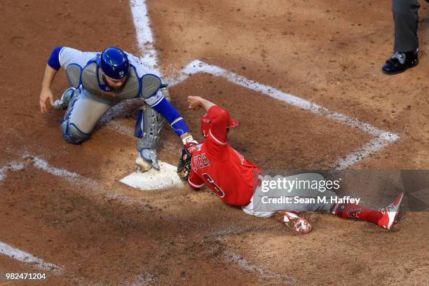 David Fletcher of the Los Angeles Angels of Anaheim is tagged out at homeplate by Russell Martin of the Toronto Blue Jays during the third inning of...