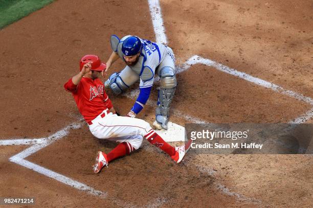 David Fletcher of the Los Angeles Angels of Anaheim is tagged out at homeplate by Russell Martin of the Toronto Blue Jays during the third inning of...