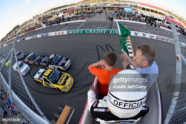 Grant Enfinger, driver of the Champion Power Equipment Ford, and Christian Eckes, driver of the Mobil 1 Toyota, lead the field past the green flag to...