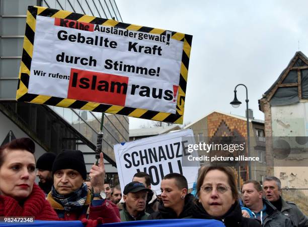 Right-wing group carries a banner reading 'Islam raus' and 'Schnauze voll' to protest against the perceived 'Islamisation' of society through...