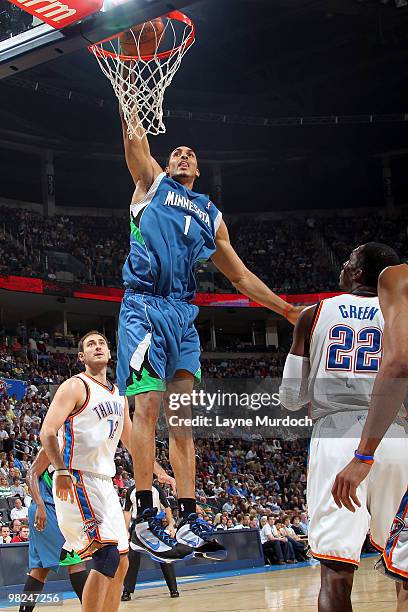 Ryan Hollins of the Minnesota Timberwolves dunks the ball on Jeff Green of the Oklahoma City Thunder on April 4, 2010 at the Ford Center in Oklahoma...