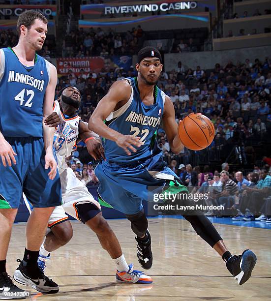 Corey Brewer of the Minnesota Timberwolves uses a screen set by team mate Kevin Love, to get around James Harden of the Oklahoma City Thunder on...