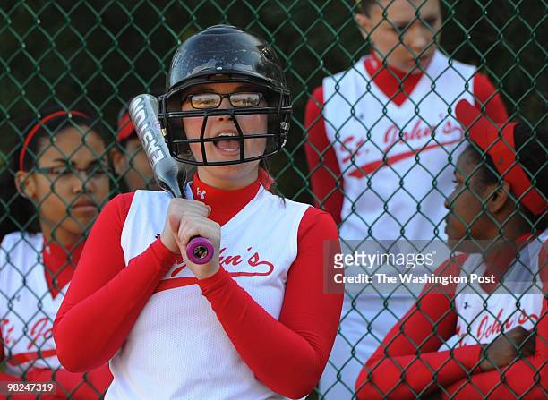 March 31: St. John's College High School sophomore Lindsey Ganey cheers on her teammate while waiting for her turn to hit during the game against...