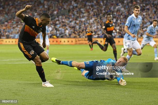 Sporting Kansas City goalkeeper Tim Melia stops a point blank range shot from Houston Dynamo forward Mauro Manotas in the second half of an MLS match...