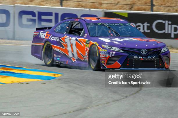 Denny Hamlin hits the brakes hard as he goes through Turn 4 on his qualifying session for the Monster Energy NASCAR Cup Series - Toyota/Save Mart 350...