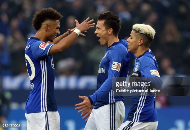 Dpatop - Schalke's Yevhen Konoplyanka celebrates scoring his side's first goal with teammates Thilo Kehrer and Amine Harit during the German...