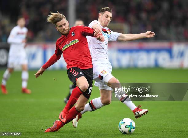 Freiburg's Lucas Hoeler and Leverkusen's Dominik Kohr battle for the ball during the German Bundesliga football match between SC Freiburg and Bayer...